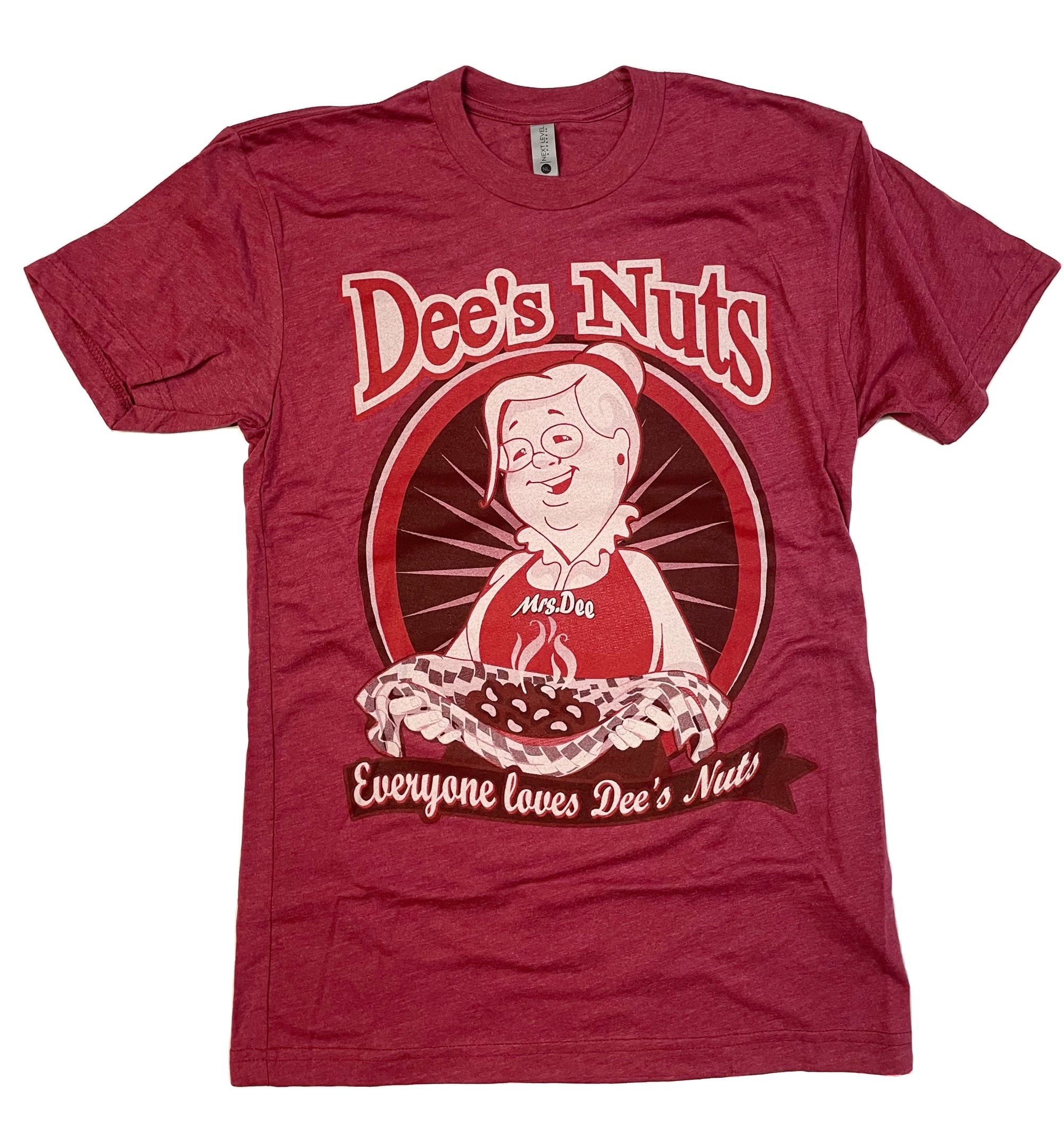 Red Dee's Nuts t-shirt featuring a retro cartoon graphic of "Mrs. Dee" holding a steaming tray of peanuts. The design includes the bold Dee’s Nuts logo at the top and the slogan “Everyone loves Dee’s Nuts” in white script on a brown ribbon banner. Playful and nostalgic apparel promoting the Dee’s Nuts brand.